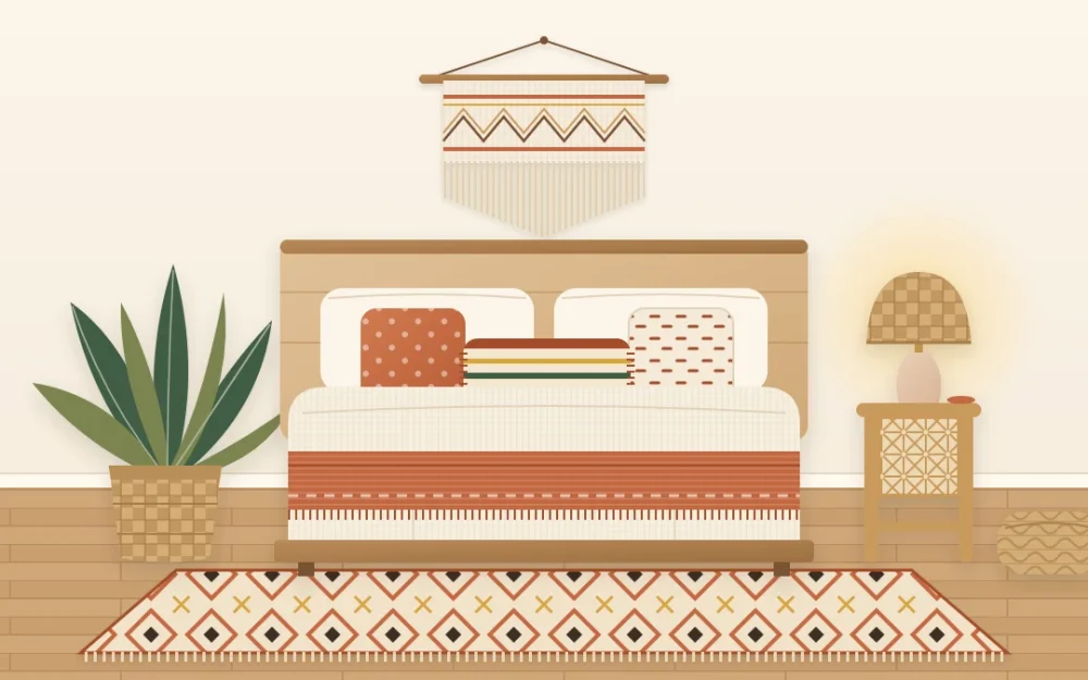 Warm boho bedroom with a low wooden bed, layered cream and terracotta bedding, a woven wall hanging, a rattan bedside table and a patterned rug