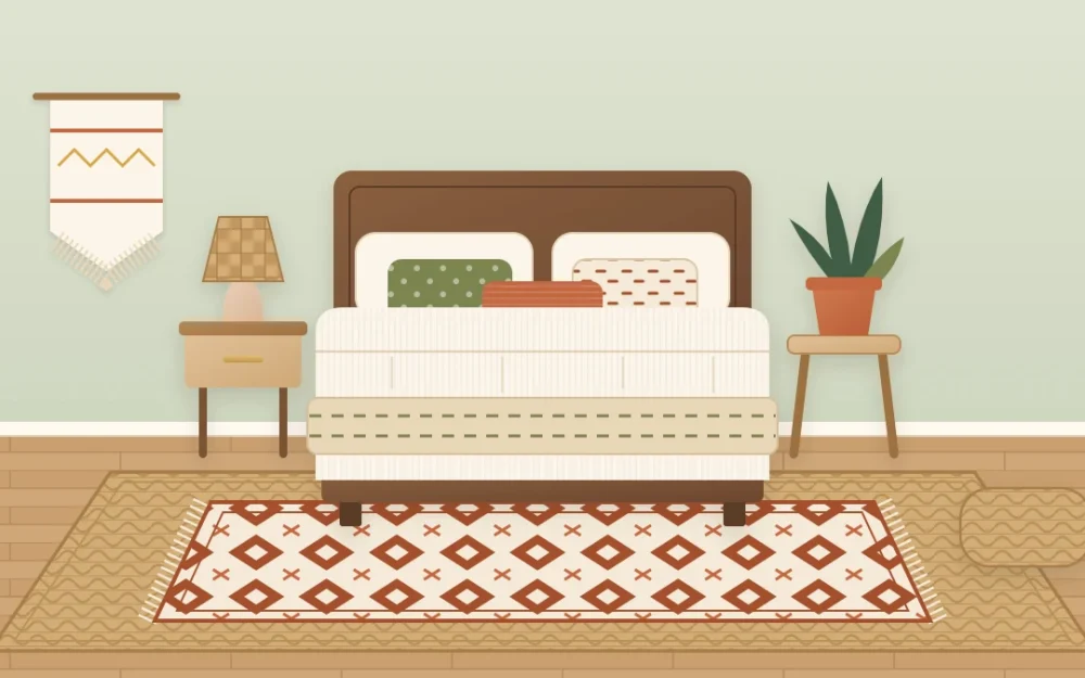 Bedroom seen from the foot of the bed with a rust and cream flat-woven rug layered over a larger braided jute rug that extends past both sides of the bed