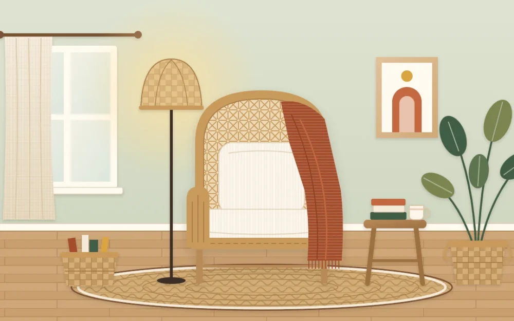 A boho reading corner with a rattan armchair, cream cushion and rust throw, a glowing woven-shade floor lamp, a wooden stool, a round jute rug and a plant in a basket