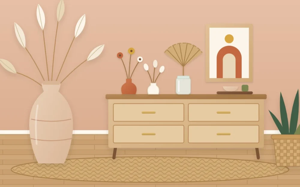 Tall clay floor vase of feathery dried grasses beside a wooden dresser holding two bud vases of dried flowers and a dried fan-shaped leaf in a jar